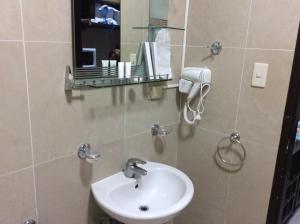 a bathroom with a sink and a mirror at Bourbon St Apts Condo 30C in Angeles +8 photos