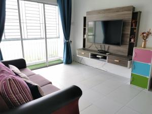 a living room with a couch and a television at Lake Residence 167 aesthetic lakeview best photograph in Putrajaya