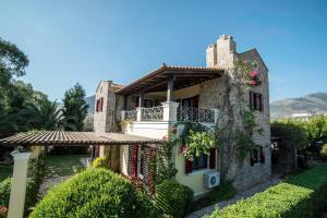 an old stone house with a balcony at Galaxidi Mansion in Galaxidhion