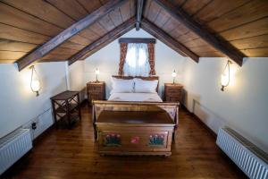 a bedroom with a bed and a wooden ceiling at Galaxidi Mansion in Galaxidhion