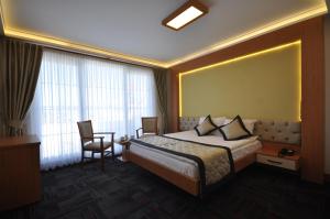 a hotel room with a bed and a table and chairs at Double Comfort Hotel in Ankara