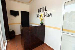 a room with a hotel micropolitanha sign on the wall at Nicol-Haa in Izamal