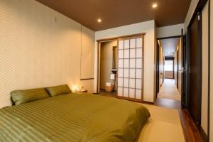 A bed or beds in a room at Iroha Nozawa