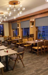 a restaurant with tables and chairs and windows at Hotel Lorösch in Bad Orb