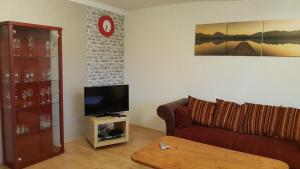 a living room with a couch and a tv at Am alten Fachwerk in Monschau