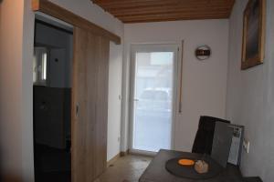 a living room with a table and a sliding door at Gästehaus Lehr in Kinding