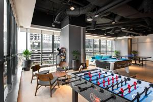 a living room with a large pool table and a pool table at Komune Living in Kuala Lumpur