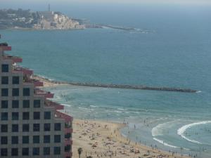 a view of a beach with people and the ocean at Elena Apartments in Tel Aviv