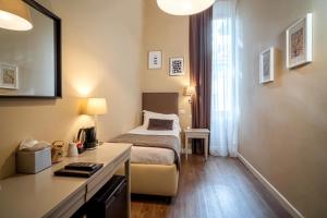 a hotel room with a bed and a desk at Dedo Boutique Hotel in Florence