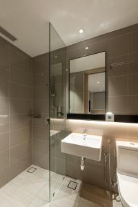 a bathroom with a sink and a mirror at Komune Living in Kuala Lumpur +33 photos
