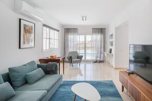 a living room with a couch and a tv at Sea view villa San Agustin vista Claveles in San Agustin