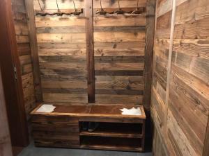 a shower in a room with wooden walls at Chata Dorotka in Vyšné Ružbachy