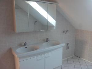 a bathroom with a sink and a large mirror at Wohnen mit Panoramablick in Gramastetten