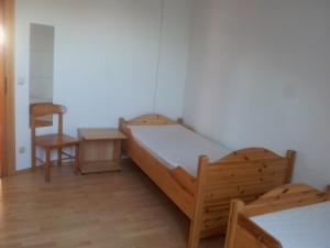 a bedroom with a bed and a table and a chair at Wohnen mit Panoramablick in Gramastetten