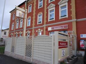 a building with a white fence in front of a building at Pension Dresdener Panorama in Dresden