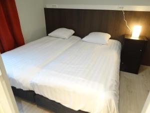 A bed or beds in a room at Albert - Rooms