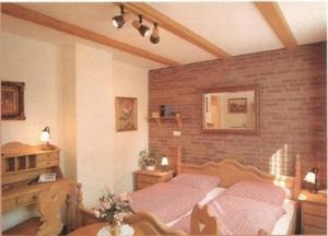 a bedroom with a bed and a brick wall at Hotel Gastgeb in Essen +32 photos