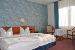 Postel nebo postele na pokoji v ubytování Hotel Pesterwitzer Siegel