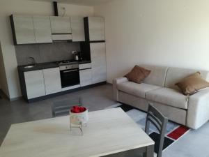 a living room with a table and a couch at oleandra in Nesso