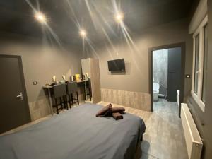 a bedroom with a bed and a dining room with a table at Appartement Studio Tournai in Tournai