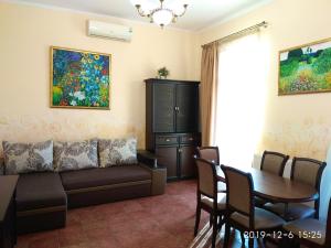 a living room with a couch and a table at Aparthotel NA DOBU in Lviv