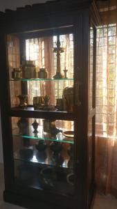 a cabinet filled with lots of pots and pans at Nirrvaan homestay in Varkala