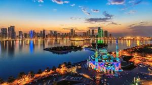 a view of a city skyline at night at Al Rawdha Hotel Apartments in Sharjah
