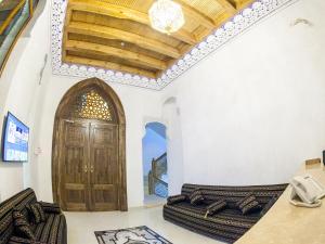a room with a wooden door in a building at Royal Bukhara hotel in Bukhara