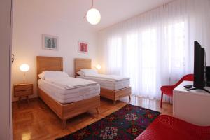 En eller flere senge i et værelse på Central Residence