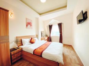 Postel nebo postele na pokoji v ubytování Vanilla Dalat Hotel