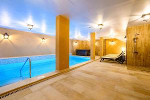 a large swimming pool in a house with a pool at Antique Boutique Hotel in Pavel Banya
