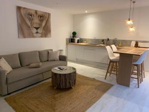 a living room with a couch and a lion painting on the wall at Victoria's House in Lille