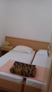 a pair of beds in a room with a purse at Apartments Vrša in Seline