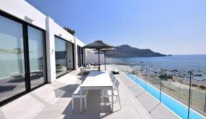 a view of the ocean from the balcony of a house at Villa Nostos Plakias beachfront sea view privet pool in Plakias