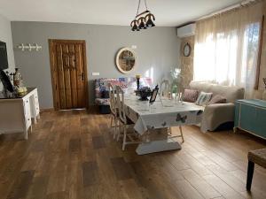 a living room with a table and a couch at Finca La Marquesa - Cuenca in Valera de Abajo