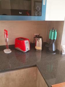 a kitchen counter with a toaster and appliances on it at Departamento Nuevo Plaza Ñuñoa in Santiago