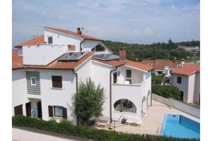 a large white house with a swimming pool at Ferienhaus Bozena Appartment 1 in Vrsar