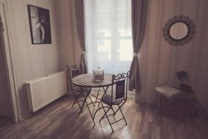 a table and chairs in a room with a window at GITE LE SAINT-AMOUR in Saint-Amour