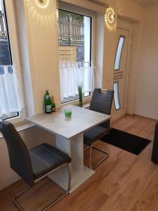 a dining room with a table and two chairs at 30 qm Apartment super zentral in Melsungen in Melsungen