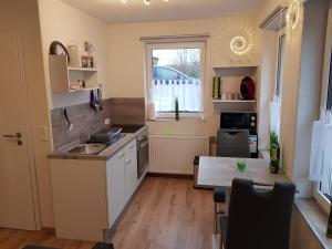 a kitchen with a sink and a table and a window at 30 qm Apartment super zentral in Melsungen in Melsungen