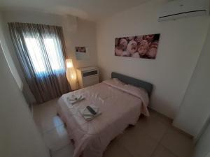 a small bedroom with a bed and a window at San Marco Beach App Libeccio in Agropoli