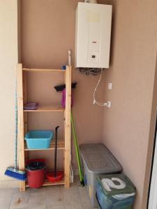 a utility room with a washing machine and a shelf at San Marco Beach App Libeccio in Agropoli +33 photos
