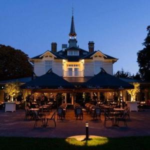 a restaurant with tables and chairs in front of a building at WesterVilla in Amsterdam