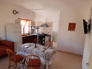 a kitchen with a table and chairs in a kitchen at Apartamento en salta in Salta