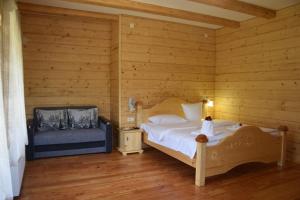 a bedroom with a bed in a wooden room at VIOLETTA in Slavske +48 photos