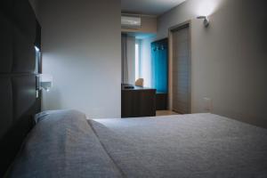 Postel nebo postele na pokoji v ubytování Hotel Casale dei Greci