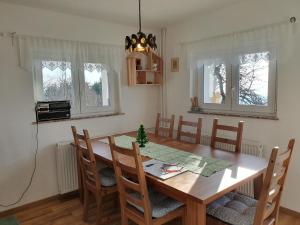 a dining room with a wooden table and chairs at Veronica's place in the mountains in Cerklje na Gorenjskem