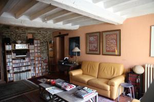 a living room with a couch and a table at La Grange Ô Belles in Champfrémont