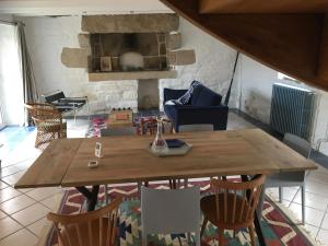 a wooden table and chairs in a living room at Maison près de l'Océan in Pont-Croix +36 photos