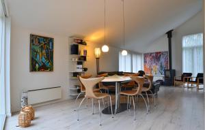 a dining room and living room with a table and chairs at Amazing Home In Græsted With Kitchen in Græsted
